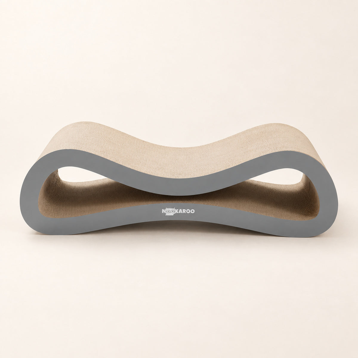Low front view of the Nookaroo Agatha cardboard cat scratcher and lounge on a warm cream background