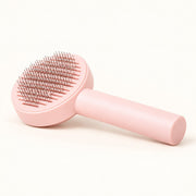 View image 1: Single pink Daily Groom self-cleaning cat brush