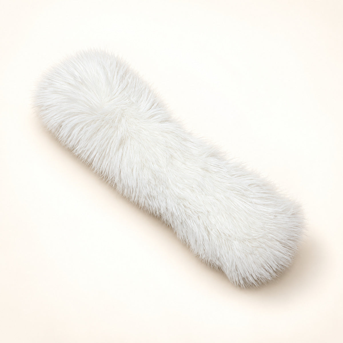 White long-haired plush catnip pillow on a warm ivory background