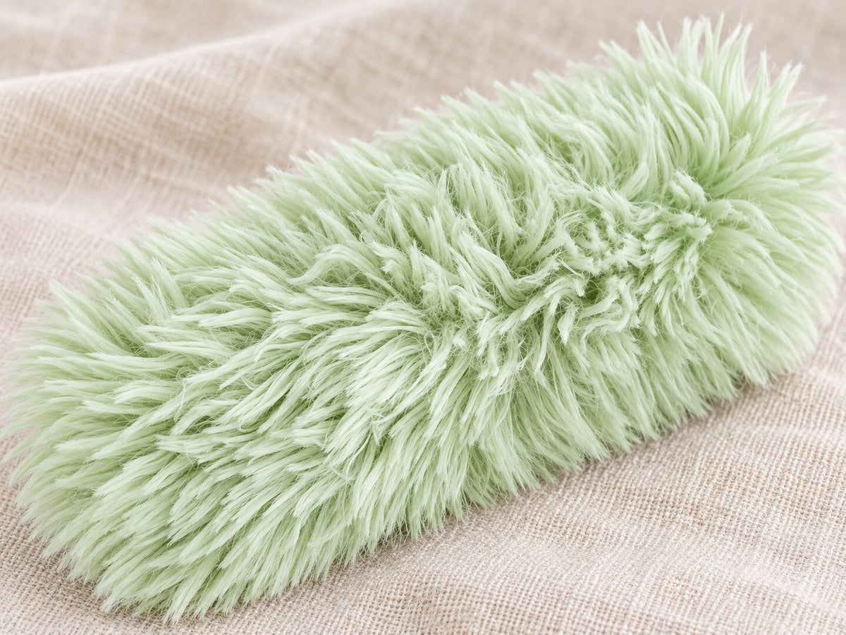 Close detail of the long plush fibers on the light-green Cloud toy — styled supplier image