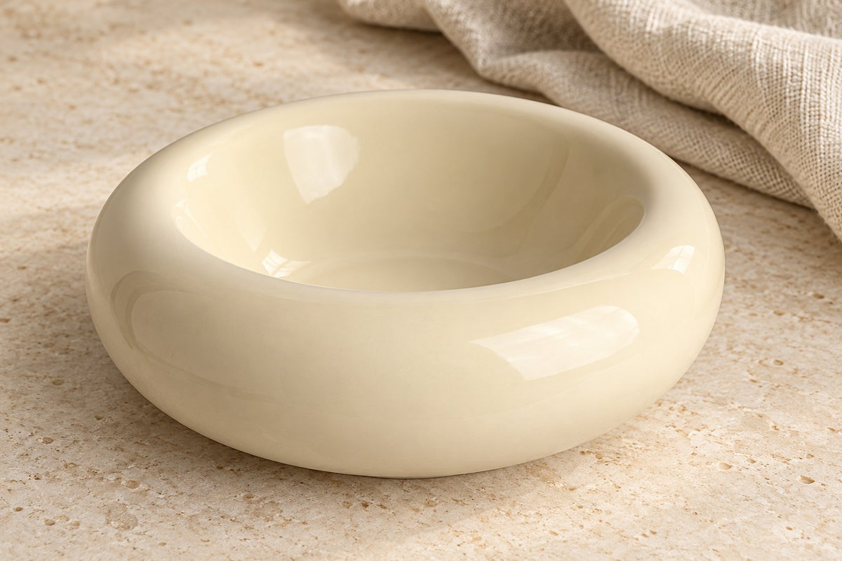 Close view of the cream bowl's rounded rim and glossy ceramic interior