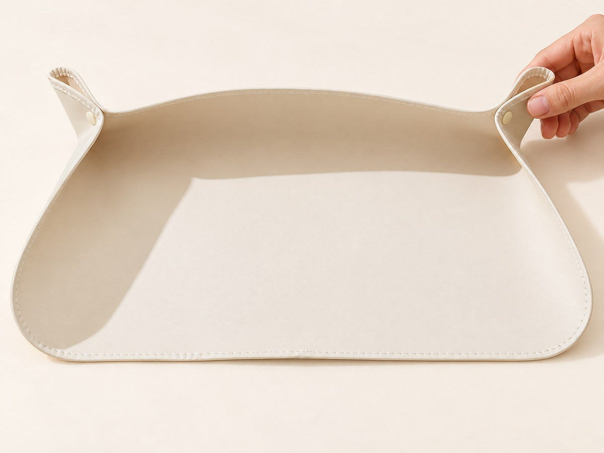 Cream feeding mat with both corner snaps fastened, raised back and sides, and an open front