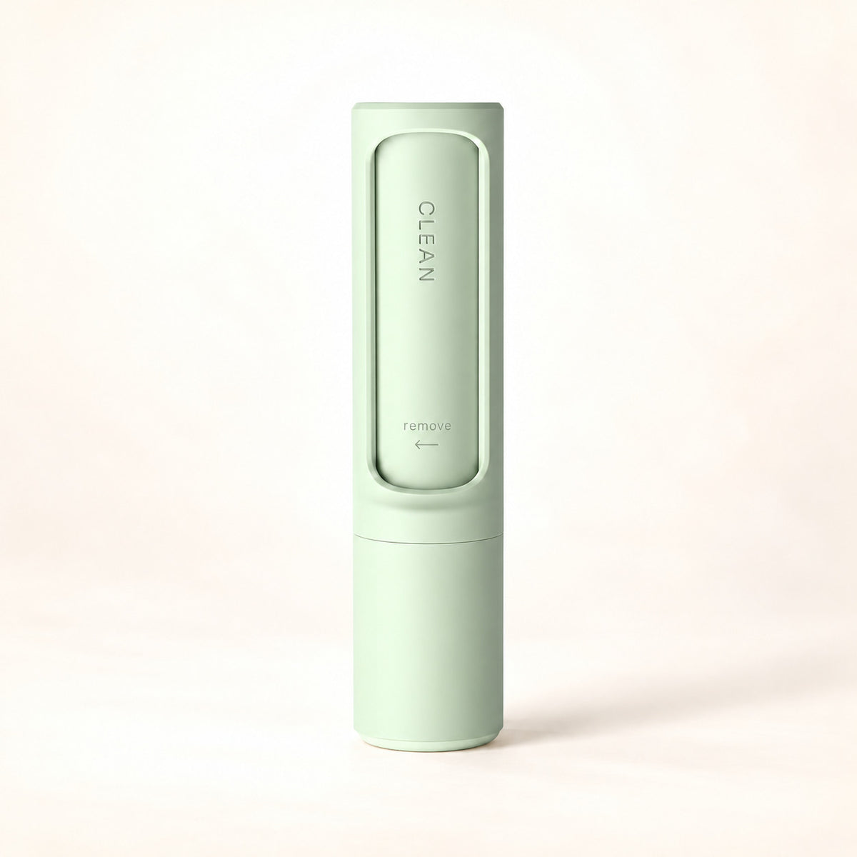 Mint-green reusable pet hair remover in its self-cleaning case on a warm ivory background