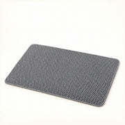 View image 1: Gray double-layer honeycomb litter mat with rounded corners on a warm ivory background