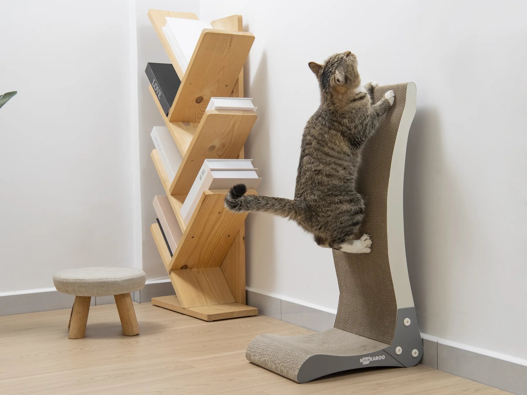 Tabby cat enjoying a full-body stretch on the tall Bennu scratcher